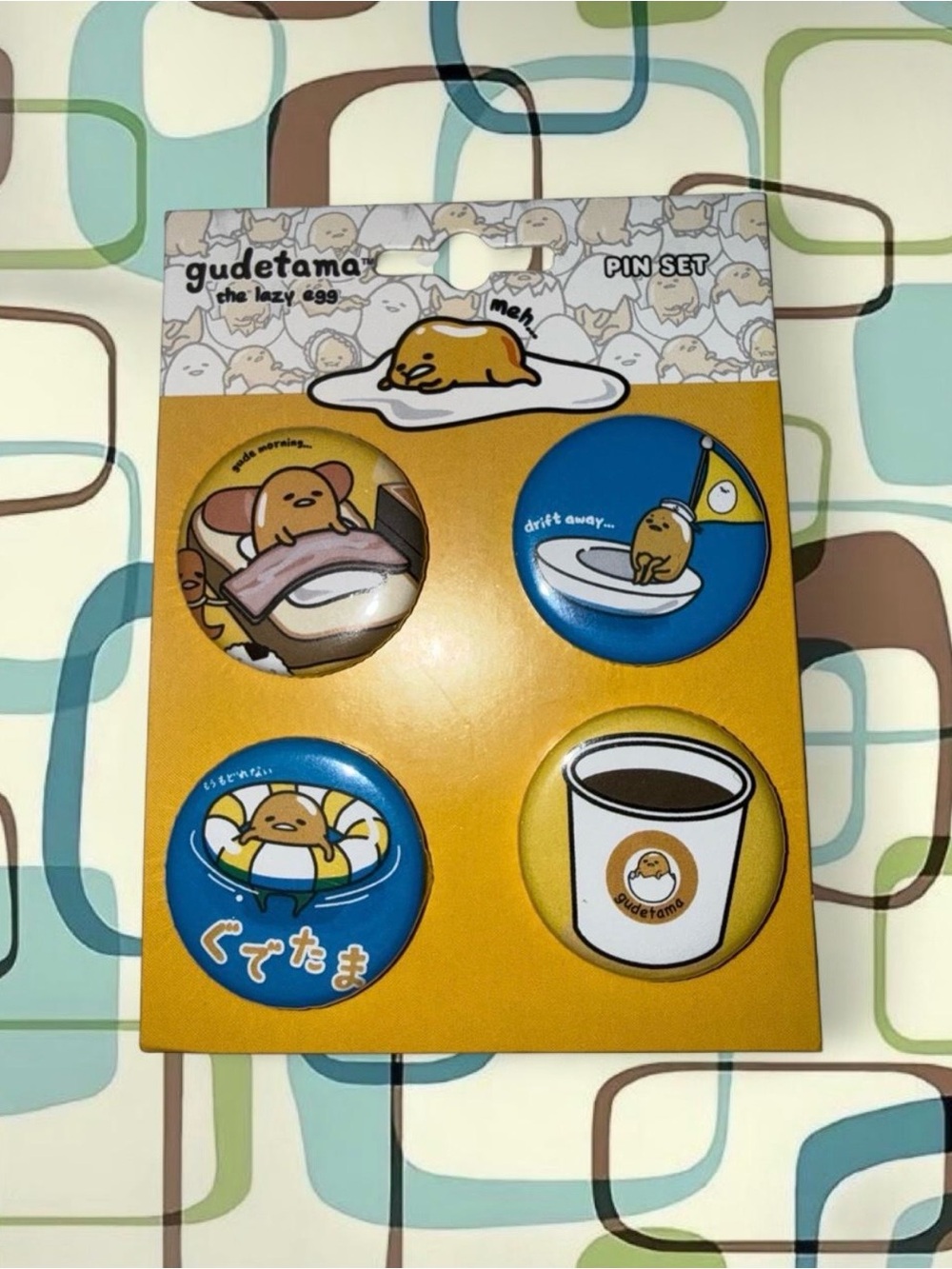 Gudetama pin set with 4 pins featuring Gudetama in various poses and settings